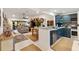 Open-concept living room with dining area and modern kitchen, perfect for entertaining at 2160 Biller Cir, The Villages, FL 32163