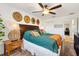 Primary bedroom featuring a ceiling fan, natural light, and decorative wall hangings at 2160 Biller Cir, The Villages, FL 32163
