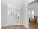 Bright foyer with decorative tile floors, high ceilings, and a beautiful front door at 21926 King Alfred St, Leesburg, FL 34748