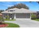 Beautiful single-Gathering home showcasing a pristine, landscaped front yard and an attached two-car garage at 21926 King Alfred St, Leesburg, FL 34748