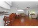 Open-concept living area with hardwood floors seamlessly connects the kitchen, dining, and lounging spaces at 21926 King Alfred St, Leesburg, FL 34748