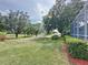 Expansive backyard borders a serene golf course, framed by mature trees, and offers a tranquil outdoor setting at 2415 Twickingham Ct, Clermont, FL 34711