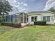 Lush backyard with a screened patio and well-maintained landscaping at 2415 Twickingham Ct, Clermont, FL 34711