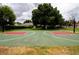 Outdoor basketball court with green and red playing surface, basketball hoops, and surrounding greenery at 2415 Twickingham Ct, Clermont, FL 34711