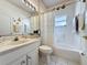 Clean bathroom featuring a bathtub and shower, white tiles, and a sink at 2415 Twickingham Ct, Clermont, FL 34711