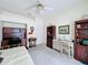 Well-lit bedroom featuring neutral carpet, a ceiling fan, and furniture at 2415 Twickingham Ct, Clermont, FL 34711