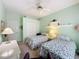 Bright bedroom featuring two twin beds, a ceiling fan, a closet, and natural light at 2415 Twickingham Ct, Clermont, FL 34711