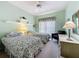 Bright bedroom featuring two twin beds, a ceiling fan, a closet, and natural light at 2415 Twickingham Ct, Clermont, FL 34711