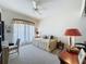 Cozy bedroom featuring soft natural light, light carpet, and furniture at 2415 Twickingham Ct, Clermont, FL 34711