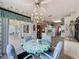 Breakfast nook boasting a chandelier and views of the lanai and surrounding greenery at 2415 Twickingham Ct, Clermont, FL 34711