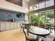 Community coffee bar with tables, chairs, coffee station, and a large window with a view of the tropical landscape at 2415 Twickingham Ct, Clermont, FL 34711