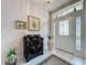 Bright foyer with decorative cabinet and tiled flooring at 2415 Twickingham Ct, Clermont, FL 34711