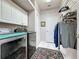 Well-equipped laundry room with modern appliances and convenient storage solutions at 2415 Twickingham Ct, Clermont, FL 34711