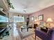Comfortable living room featuring neutral furniture, a ceiling fan, and a large window at 2415 Twickingham Ct, Clermont, FL 34711