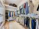 Spacious walk-in closet with custom shelving and ample hanging space for organized storage at 2415 Twickingham Ct, Clermont, FL 34711