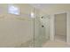 Bathroom featuring glass-enclosed shower with decorative etching and tiled floor at 2424 Plumadore Dr, Grand Island, FL 32735