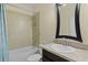 Bathroom features a modern vanity with a granite countertop, stylish mirror, and tiled shower/tub combo at 2424 Plumadore Dr, Grand Island, FL 32735