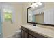 Bathroom featuring a modern vanity with a granite countertop, stylish mirror, and blue drapes at 2424 Plumadore Dr, Grand Island, FL 32735