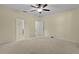 Bedroom with a ceiling fan and doorways to the bathroom and walk-in closet at 2424 Plumadore Dr, Grand Island, FL 32735