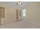 Bedroom featuring built-in shelving and storage, maximizing space and organization with natural light at 2424 Plumadore Dr, Grand Island, FL 32735