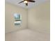 Bright bedroom featuring a large window with natural sunlight with neutral colors at 2424 Plumadore Dr, Grand Island, FL 32735