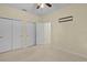 Bright bedroom featuring a neutral color and multiple closets, providing extra storage and space at 2424 Plumadore Dr, Grand Island, FL 32735