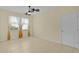 Well-lit bedroom with tile flooring, ceiling fan, and neutral wall color at 2424 Plumadore Dr, Grand Island, FL 32735