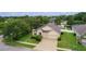 Charming home featuring a well-maintained lawn, mature trees, and a two-car garage at 2424 Plumadore Dr, Grand Island, FL 32735