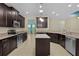 Spacious kitchen with a center island, granite countertops, and stainless steel appliances at 2424 Plumadore Dr, Grand Island, FL 32735