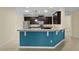Kitchen with granite countertop bar, modern appliances, and a blue accent wall at 2424 Plumadore Dr, Grand Island, FL 32735