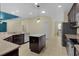 Modern kitchen featuring an island, granite countertops, and stainless steel appliances at 2424 Plumadore Dr, Grand Island, FL 32735
