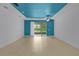 Open and airy living space with tile flooring, recessed lighting, and a sliding glass door at 2424 Plumadore Dr, Grand Island, FL 32735