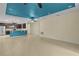Open-concept living room with tile flooring and modern ceiling fans, connected to a stylish kitchen at 2424 Plumadore Dr, Grand Island, FL 32735