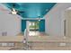 Living room features a modern color accent, tile flooring, and access to the backyard at 2424 Plumadore Dr, Grand Island, FL 32735