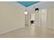 Open-concept living space with tile flooring, modern lighting, and a view into the adjacent kitchen at 2424 Plumadore Dr, Grand Island, FL 32735