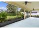 Covered lanai with view of the backyard, landscaping and lush greenery at 2424 Plumadore Dr, Grand Island, FL 32735
