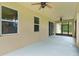 Screened porch with a view of the exterior and two ceiling fans at 2424 Plumadore Dr, Grand Island, FL 32735
