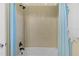 Bathroom shower featuring modern tile and black showerhead, alongside blue curtains at 2424 Plumadore Dr, Grand Island, FL 32735