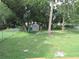 Large, grassy backyard with a chainlink fence and a storage shed at 2501 Sheridan Rd, Mount Dora, FL 32757