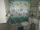 Cozy bathroom featuring a shower with a turtle-themed curtain and white fixtures at 2501 Sheridan Rd, Mount Dora, FL 32757