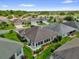 Expansive home featuring a sunroom and surrounded by lush landscaping in a serene neighborhood at 2568 Jupiter Way, The Villages, FL 32163