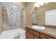 This full bathroom offers a shower/tub combo, neutral tile, and a stylish sink at 2568 Jupiter Way, The Villages, FL 32163