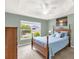 Inviting bedroom offers a lovely bed, a scenic view from the window, and a tranquil atmosphere at 2568 Jupiter Way, The Villages, FL 32163