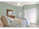 This relaxing bedroom offers a closet, a fan, and neutral paint, creating a peaceful space at 2568 Jupiter Way, The Villages, FL 32163
