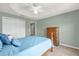 Cozy bedroom features carpet flooring, a ceiling fan, and a lovely wooden dresser with ample storage at 2568 Jupiter Way, The Villages, FL 32163