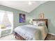 Charming bedroom features a window seat, allowing for natural light and a cozy feel at 2568 Jupiter Way, The Villages, FL 32163