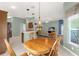 Eat-in kitchen leads to dining area and living room, creating an open-concept living space at 2568 Jupiter Way, The Villages, FL 32163