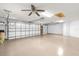 The garage has an insulated door, ceiling fan and painted flooring at 2568 Jupiter Way, The Villages, FL 32163