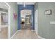 Hallway with wood-look flooring and views into living room at 2568 Jupiter Way, The Villages, FL 32163