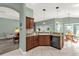 Modern kitchen featuring a breakfast bar, black appliances, and open layout to the living spaces at 2568 Jupiter Way, The Villages, FL 32163